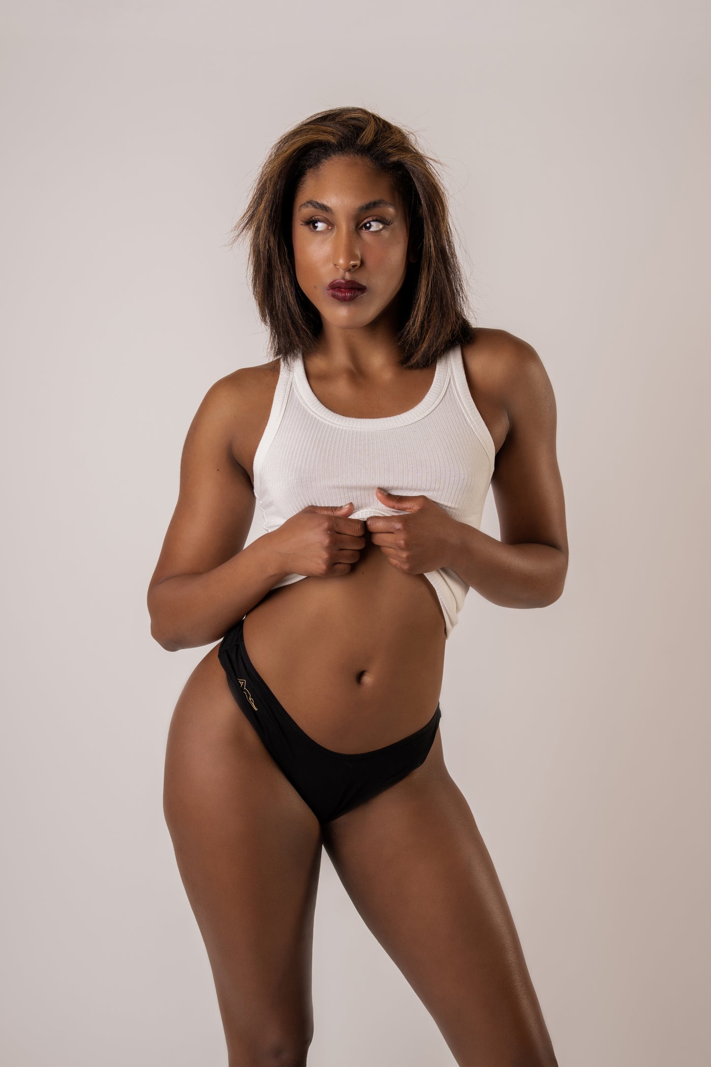 Image of woman wearing a white tank top and black Kelle'sFinery Tencel Spandex underwear posed infront of a white background