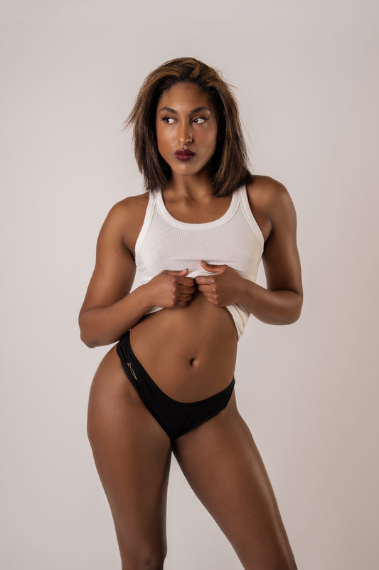 Image of woman wearing a white tank top and black Kelle'sFinery Tencel Spandex underwear posed infront of a white background