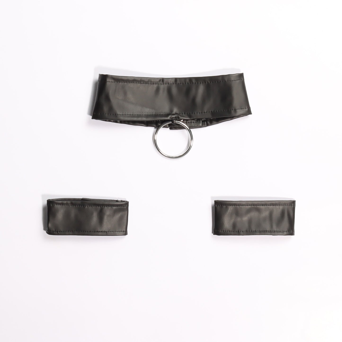 Quality faux leather collar and wrist cuffs in black with a metal O ring on a white background