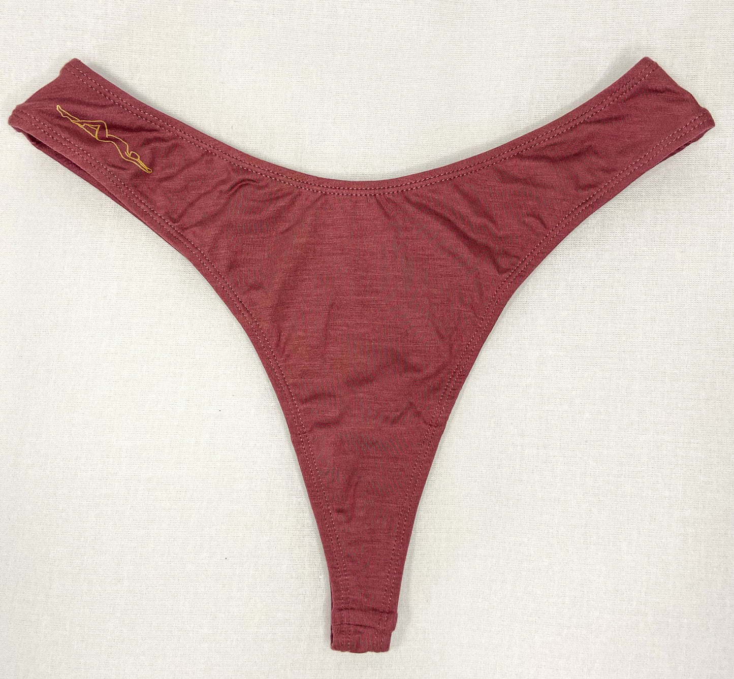 Image of upcycled Dusty Rose Kelle'sFinery Tencel Spandex underwear laid out on a white background
